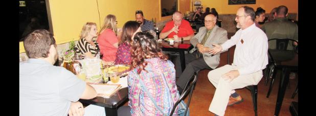 CCLP/BRITTANY FHOLER - Library director Kevin Marsh explains about the library resources available to small business owners and entrepreneurs at the first ever Young Professionals Mixer held Thursday evening at Unwind!