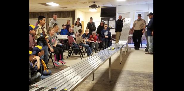 CCLP/PAMELA GRANT - Scouts and their families watch as their colorful wooden racecars zoom down the tracks during Saturday’s Pinewood Derby for Cub Scout Pack 251.