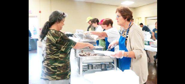 CCLP/BRITTANY FHOLER - A Sausage Fest-goer points out her sausage selection at the Trinity Lutheran Church’s Annual German Sausage Fest held Saturday at the Copperas Cove Civic Center.