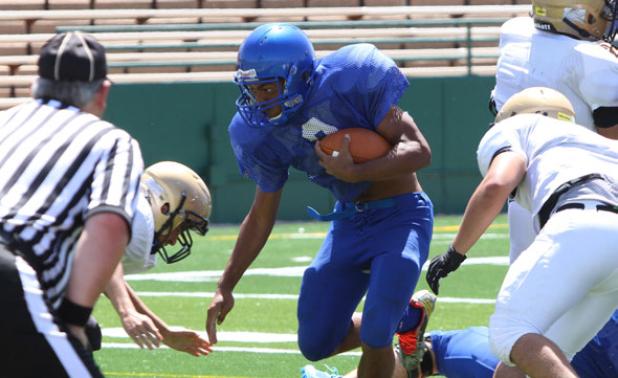 Copperas Cove junior runningback Antonio Lealiiee splits a pair of Abilene defenders on his way to the end zone during the controlled portion of their scrimmage Friday at Shotwell Stadium in Abilene.