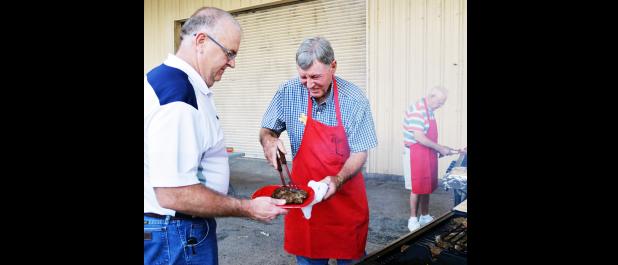 File Photo - Billy Piper puts a steak on Mike Loven’s plate at a past Military Affairs dinner for the 13th ESC. The dinners are on hold for 2017 at the moment.