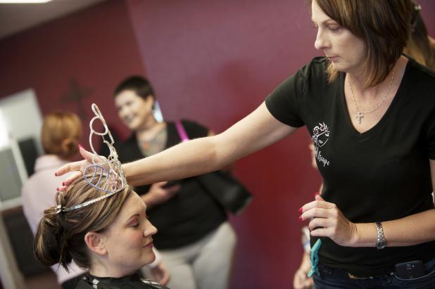 CCLP/DAVID MORRIS Tonia Lee of A Blissful Escape adjusts the crown of Ms. Rabbit Fest Trisha Stutz after styling her hair during a recent visit.