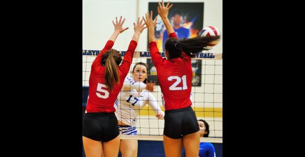 CCLP/TJ MAXWELL - Copperas Cove senior Brianna Acker hits into the defense of Midway’s Samantha Sanders (5) and Avery Rhodes during the Pantherettes 3-0 win over the Lady Dawgs Tuesday in Cove.