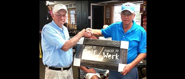 CCLP/TJ MAXWELL - Buck Wilkins, right, is presented with the Ledger Furniture donated golf plaque “Born to Golf/Forced to Work’ by Cove Bass Club secretary Jack Johnson