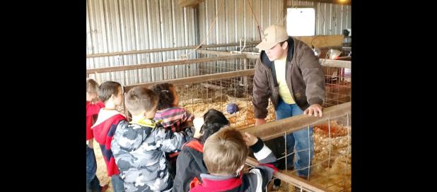 CCISD/Courtesy Photo - CCHS FFA member Colton Christman shares information about one of his livestock projects with CCISD gifted education first graders during a field trip to the CCISD Agriculture Barn. Christman raises chickens and hogs.