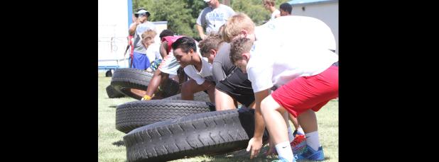 CCLP/TJ MAXWELL - Campers compete in a two-man tire relay during the annual NFL Football Camp, hosted by the Copperas Cove School District, on Wednesday at Bulldawg Stadium.