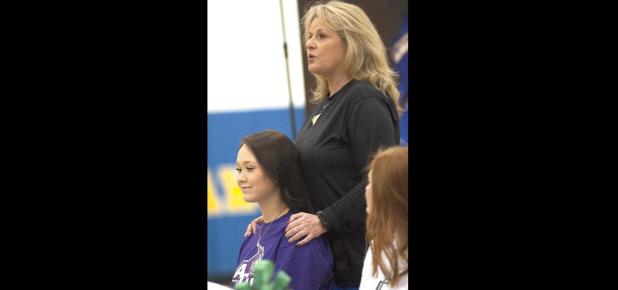 CCLP/DAVID MORRIS - Copperas Cove head coach Cari Lowery talks about the career of Brianna Acker, left, during National Signing Day festivities Wednesday in the high school gym.