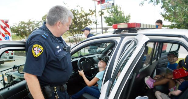 CCLP/LYNETTE SOWELL - Children explore a Copperas Cove Police Department patrol car during Tuesday evening’s Kids Club event at Chick-fil-A. This month’s theme was Salute to Courage, highlighting first responders and the military.