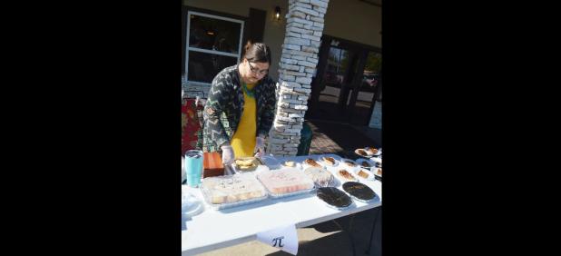 CCLP/LYNETTE SOWELL - Christy Kirkpatrick slices homemade cheesecake at Copperas Cove Nursing & Rehab’s bake sale on National Pi Day. The bake sale was held as a fundraiser for the National Alzheimer’s Association.
