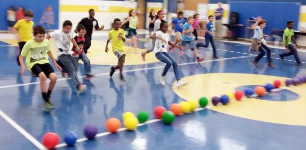 Courtesy Photo/CCISD - Clements/Parsons Elementary students rush to the center court line to grab a ball and attempt to knock out a school administrator in a friendly game of dodge ball. The school offered the opportunity to all students who had perfect attendance for the first six weeks.