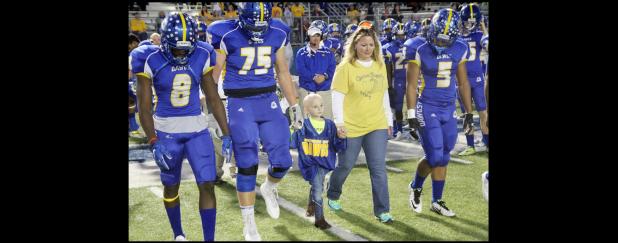 File Photos - Connor Hedger walks on the field last season with the Bulldawgs for a special presentation during a home game.