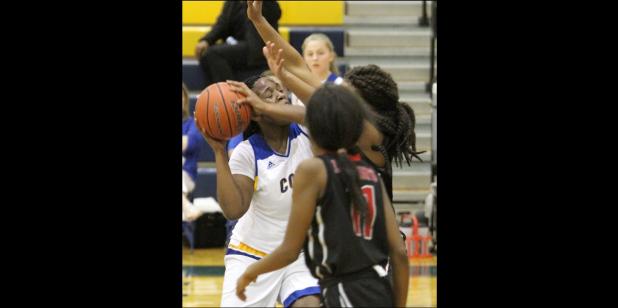 CCLP/TJ MAXWELL - Cove senior Chyanne Chapman draws a foul on a putback attempt in the second half of the Lady Dawgs’ 49-25 win over the Harker Heights Lady Knights Tuesday at Bulldawg Stadium. Chapman had a double-double with 10 points and 14 rebounds to help lead the Lady Dawgs to victory.