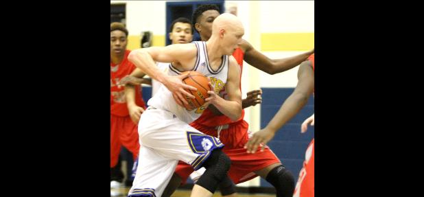 CCLP/TJ MAXWELL - Cove senior Wyatt Behara drives through the lane against Belton. Behara finished with eight points and eight rebounds for the Dawgs.