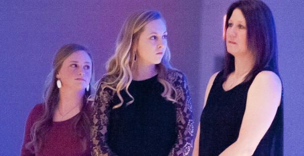 CCLP/TJ MAXWELL - Cove seniors Bailey French, from left, Katy Ranes, and assistant coach Kristy Thompson look on as head coach Cari Lowery speaks during the annual banquet on Wednesday.