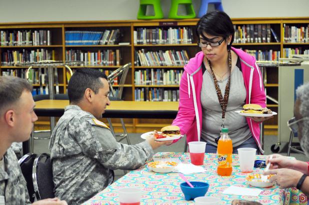 Crossroads High School student Cheyenne Chapman serves a meal she made herself through her Lifetime Nutrition and Wellness class to Second Lieutenant Milan Jairo. Half of Chapman’s grade on the project was based on how the presentation and taste of her food was rated by the luncheon’s guests.