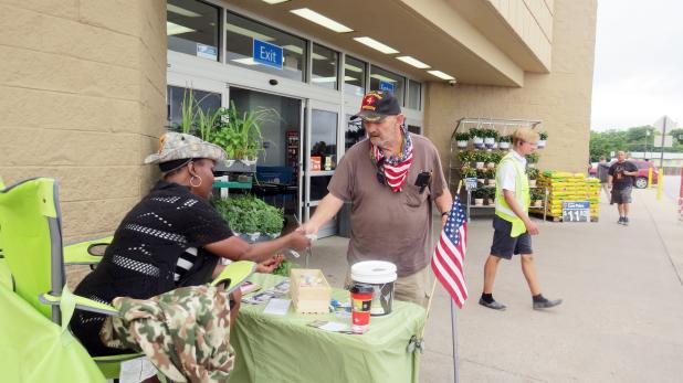 CCLP/DAVID J. HARDIN  A shopper makes a donation to the Disabled American Veterans Chapter 74 during the Forget-Me-Not drive held Saturday at Walmart. 
