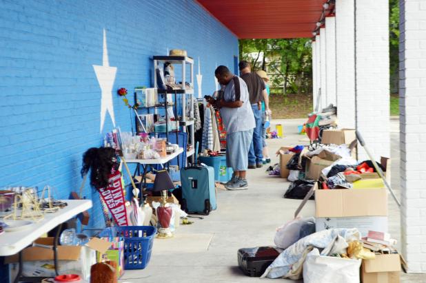 CCLP/LYNETTE SOWELL Customers check out the variety of items at a storage unit sale, held by Armadillo Properties. The real estate management company is donating the sales from the two-day event to Cove House Emergency Homeless Shelter. 