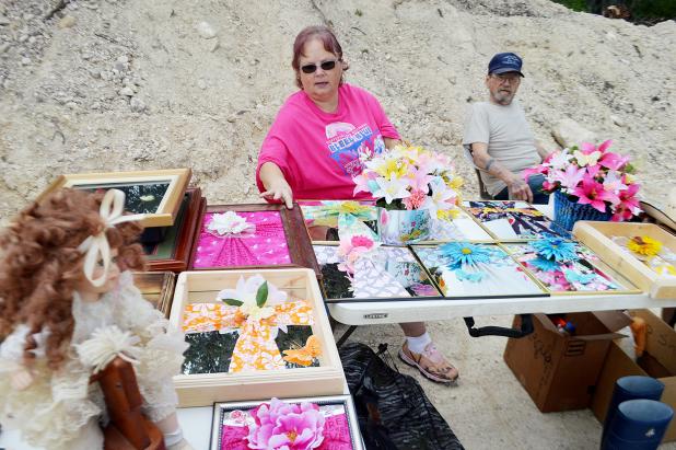 CCLP/LYNETTE SOWELL Barbara Jordan talks about the handmade decorated mirrors and other crafts for sale at the Cove Flea Market on Saturday. 