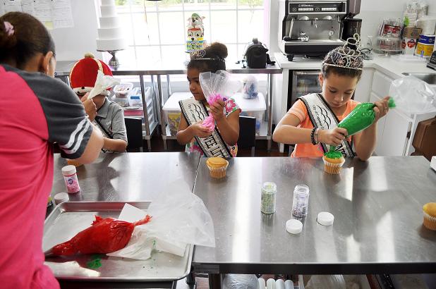 Royalty from the Copperas Cove Rabbit Fest Scholarship Pageant decorate cupcakes during a visit to Bits N Bites shop, Wednesday afternoon.  The specialty cake shop will be the after party sponsor for the inaugural Five Hills Scholarship Pageant on May 13 at Lea Ledger Auditorium.