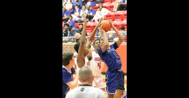 CCLP/TJ MAXWELL - Copperas Cove senior Dahmir Pearson attempts a shot in traffic with Cedar Hill 6-feet-8 sophomore Sammie Freeman and senior forward Xavier Whitaker (4) defending. Pearson led the Bulldawgs’ scoring with 14 points, including 12 for 14 free throws.