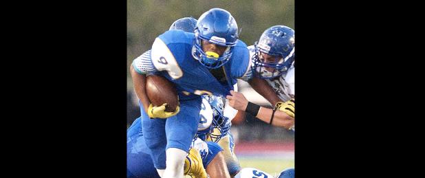 CCLP/DAVID MORRIS - Cove senior running back Elijah Washington fights off a tackler during the Dawg’s opener against UANL.