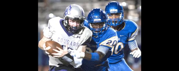 CCLP/DAVID MORRIS - Cove senior defensive linemen Eric Cain (20) and Rylan Hunter swarm El Paso Franklin quarterback Kaleb Hatch for a sack in the Dawgs’ 42-10 win on Friday.