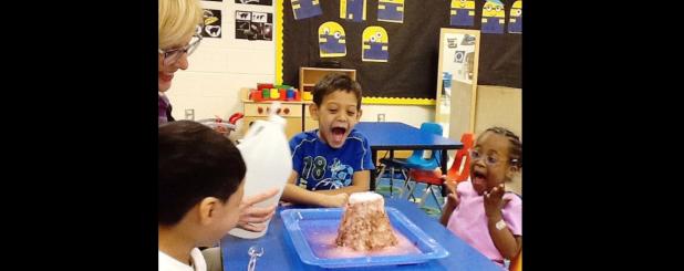 CCISD/Brandy Petty - Three- and 4-year-olds Ezekiel Garcia, Lashia Jones and Asher Diaz scream with excitement as they watch a volcano they built erupt in their classroom. The project met several pre-K learning guidelines in science as well as life skills.