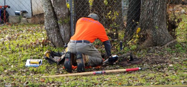 CCLP/LYNETTE SOWELL - A worker for FATHOM water Systems Inc. works to change out a water meter for a city utility customer.