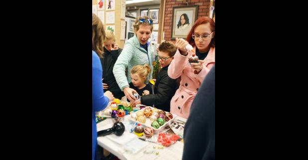 CCLP/LYNETTE SOWELL - Families lined up to decorate ornaments on Monday at Frames & Things at the Crafting With Santa event.