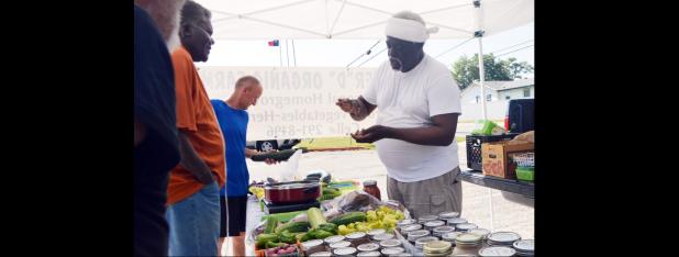CCLP/LYNETTE SOWELL - Ferrell Davis, owner of Master “D” Organic Farm, talks about how to prepare fried green tomatoes. Davis sells produce at the Copperas Cove Farmer’s Market, located in the parking lot of the VFW Post 8577 on Veterans Avenue.