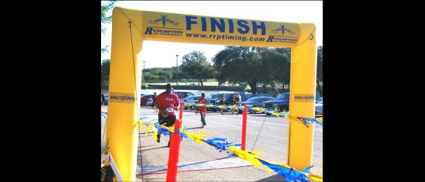 File Photo - HEB Plus General Manager Tim Smith crosses the finish line during last year’s Gallop or Trot 5K at Copperas Cove City Park. This years event will be a chip timed event on Saturday, Sept. 17.