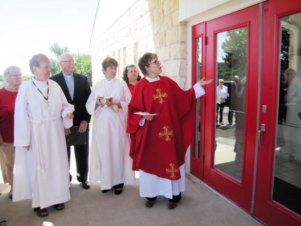 CCLP/PAMELA GRANT  Vicar Paulette Magnuson blesses the doors of St. Martin’s Episcopal Church on Sunday morning during a special ceremony.