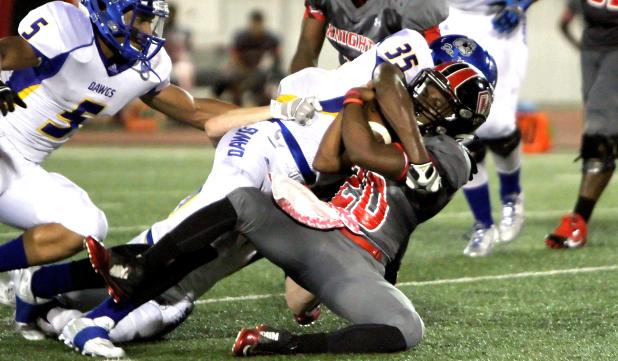 Cove junior linebacker Tyson Curry makes a tackle on Heights senior running back Taquan Berry during the Dawgs 27-15 win over the Knights Friday at Leo Buckley Stadium.