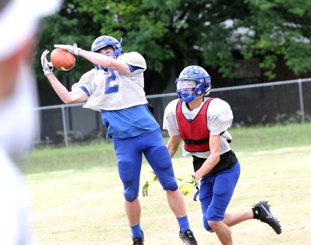 CCLP/TJ MAXWELL ABOVE: Copperas Cove slot receiver to-be senior Bryce Ranes pulls down a pass in front of two-way senior Floyd Connell. Connell was a starting outside receiver last year before splitting time at defensive back where he led the team in interceptions despite only moving to the position midway through district play. BELOW: To-be senior quarterback Jaylen Smith warms up his throwing arm during practice Tuesday at Copperas Cove High School. 
