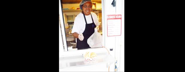 CCLP/LYNETTE SOWELL - Ileana Abascal passes a sandwich through the window of the food truck as she serves customers at their new location in Copperas Cove.
