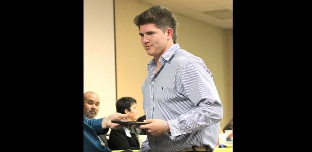 CCLP/TJ MAXWELL -- Cove senior J.P. Urquidez is given a plaque for Bulldawg Lineman of the Year during the annual football banquet last Wednesday. Urquidez was recently named to the USA Today All-USA Texas Team.