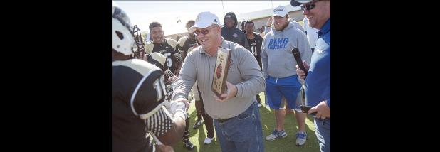 CCLP file photo - Jack Welch, head football coach/athletic director for Copperas Cove and C.H.A.M.P.S. Heart of Texas Bowl founder, hands the MVP trophy to Eastern Central Community College defender Austin Balthazor after last year’s NJCAA contest. Balthazor had six tackles and a 90-yard fumble return for a touchdown to earn the MVP for the Warriors. This year’s NJCAA game will pit Trinity Valley Community College against Northwest Mississippi Community College.