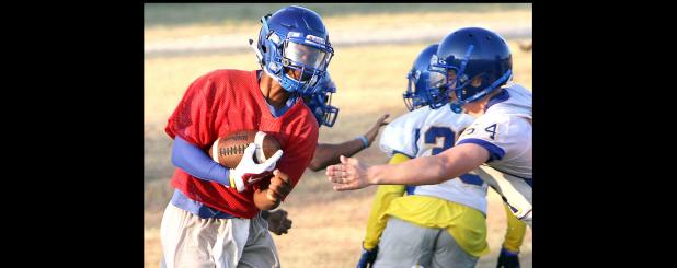 CCLP/TJ MAXWELL - Cove junior quarterback Jaylen Smith runs through the middle on a quarterback keeper during practice on Wednesday. Smith is expected to take of the majority of snaps at quarterback with last year’s starter Caine Garner expected to expand his role to receiver.