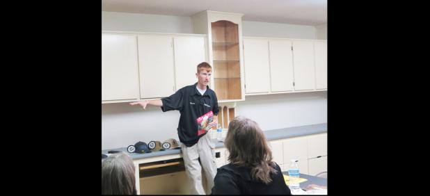 CCLP/BRITTANY FHOLER - Jimmy Gasaway, manager at PAR Guns, talks about the meals that come in the survival food bucket sold in store at the Surge meeting held Tuesday evening at PAR Guns.