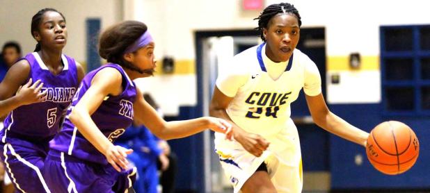 Copperas Cove senior Kenya Haynes streaks past a pair of University defenders in their 64-24 win over the Lady Trojans on Monday.