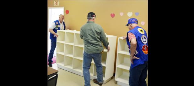 CCLP/LYNETTE SOWELL - Members of the Lone Star Travelers install the cubbies at the Copperas Cove MHMR Comprehensive Training Center.