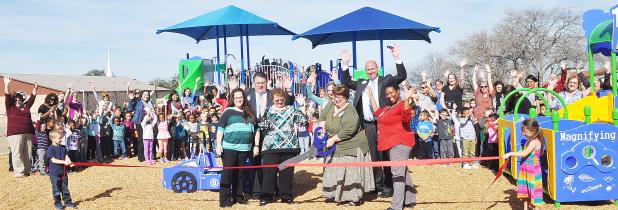 COURTESY PHOTO - Mae Stevens Early Learning Academy principal Mary Derrick cuts the ribbon on the school’s new playground surrounded by school staff and CCISD superintendent Joe Burns and deputy superintendent Rick Kirkpatrick.