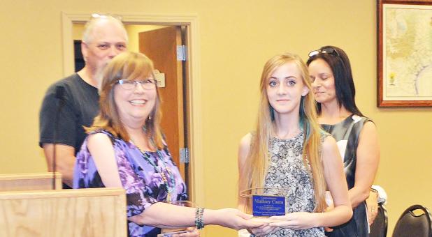 CCLP/LYNETTE SOWELL - Mallory Casto accepts her plaque on Tuesday night from the Five Hills Art Guild as one of the winners of the guild’s Art In the Park mural design contest for Fester’s House in City Park. Casto, along with Angelica Tibbit and Brice Garcia, submitted winning entries in spring 2016.