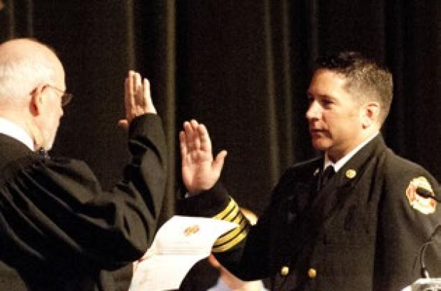 Michael Neujahr receives his oath of office from Judge Bill Price during Fridays swearing in ceremony.