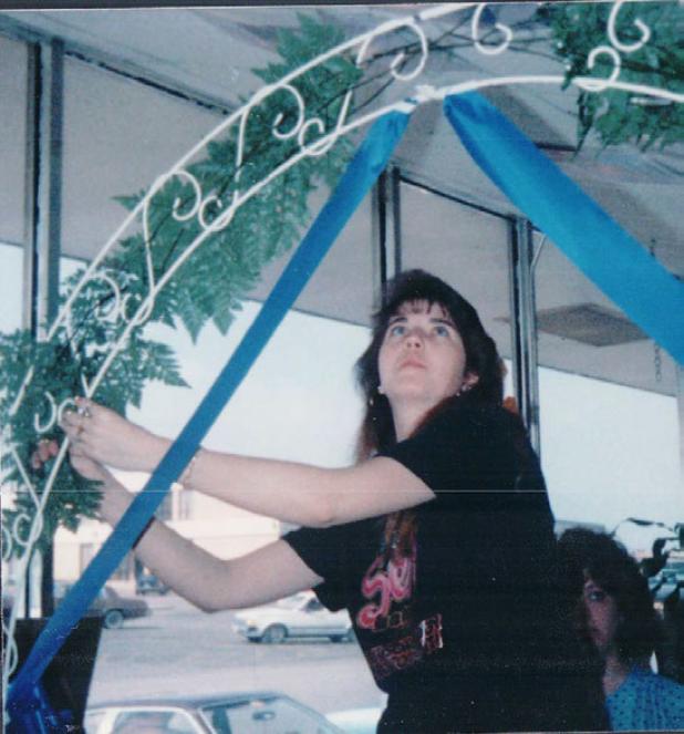 Michele McGuire works on her first floral arch for a wedding.