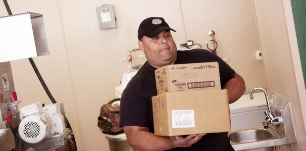 CCLP/DAVID MORRIS - Bobby Agnello, one of the owners of the new Copperas Cove Philly Pretzel Factory, prepares to load the walk-in with pretzel supplies on Wednesday afternoon. The store is set to open either today or Tuesday.