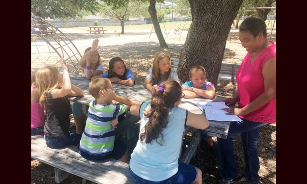Kristina Williams-Myers works with a student at Martin Walker Elementary.  Known as the kid whisperer, Williams-Myers works with students with behavior needs to help them develop social skills and replacement behaviors.