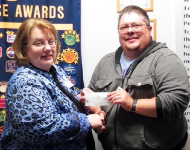 Morning Exchange Club President Mary Derrick presents Joey Ellis of Aware Central Texas with a check for $500 during their Wednesday meeting.