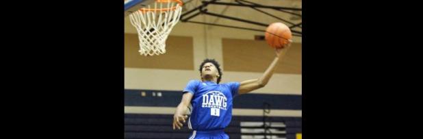 Courtesy photo - Cove sophomore Quinton Ford competes in the dunk contest during the annual Meet the Dawgs event