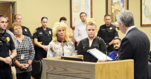 CCLP/LYNETTE SOWELL - Representative J.D. Sheffield reads a resolution honoring the late Timothy Molnes, former chief of police, as Copperas Cove police officers and department staff look on during the Copperas Cove city council workshop on Tuesday night. Sheffield presented a printed copy of the proclamation to Molnes’ wife, Tracy, and his daughter.